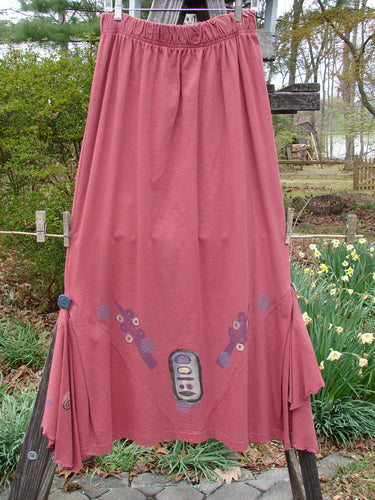 1996 Dubuffet Skirt Abstract Ember Size 2 on a wooden pole, featuring pleated diamond-shaped panels with painted buttons and removable half-circle flutters with lettuce edging, showcasing unique vintage design.