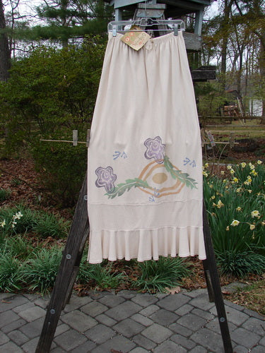 1996 NWT Spring Laughter Skirt Five Petal Birch Bark Size 2, hanging on a clothesline, showcasing its full elastic waistband, straight shape, and detailed five-petal floral theme.