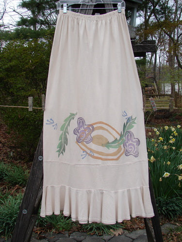 1996 NWT Spring Laughter Skirt Five Petal Birch Bark Size 2 on a clothesline, featuring a floral painted design, full elastic waistband, and flounce accented by an 8-inch lower band.