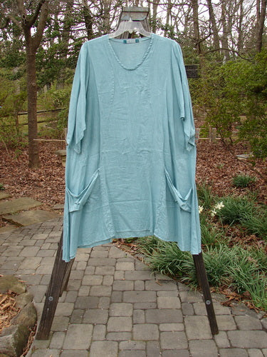 Barclay Linen Side Pocket Tab Tunic Dress Unpainted Mint Size 2 on a clothes rack, showcasing its wide short sleeves and oval neckline.