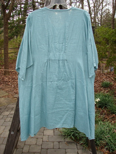 Barclay Linen Side Pocket Tab Tunic Dress Unpainted Mint Size 2 displayed on a clothes rack, featuring an oval neckline, short sleeves, and two drop flop pockets.