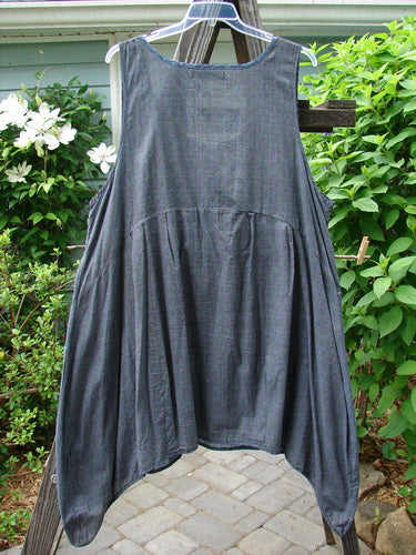 Barclay Tuesday's Pocket Prairie Dress Contrast Unpainted Grey Floral Size 2 displayed on a clothes rack, showcasing its pleated empire waist, diagonal exterior pockets, and top contrasting print piping.