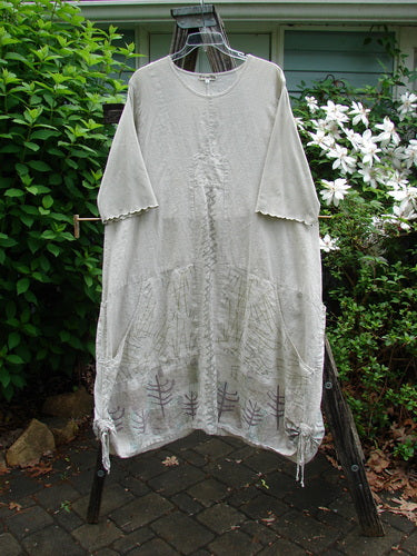 Barclay Linen Farmer Jen Dress Moon Path Flaxen Size 2, featuring a sectional bodice, drawcord sides, lower wrap pockets, paneled hem, and cotton sleeves with lettuce edges, embodying vintage Blue Fish charm.