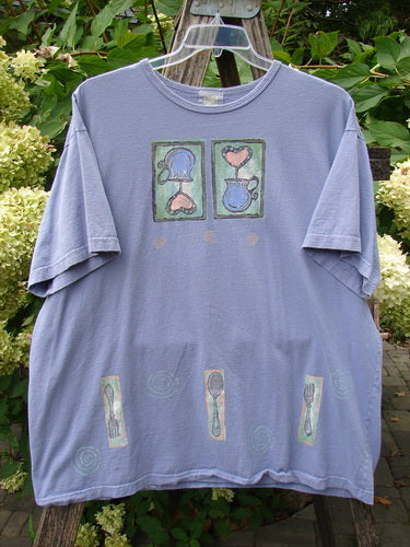 1999 Short Sleeved Tee Reverse Heart Vase Iris Size 2 features pastel pitcher and heart motifs, utensil illustrations, and a square shape with drop shoulders, embodying Bluefishfinder.com's vintage style and creativity.