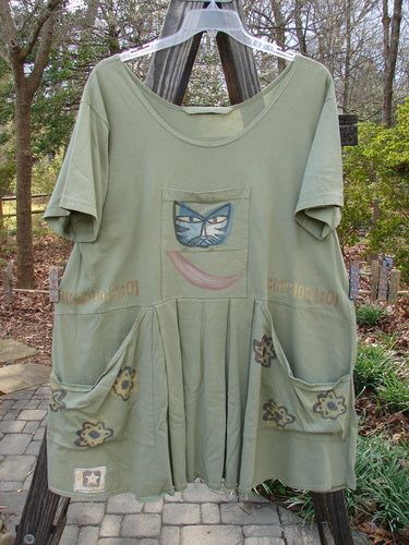 1995 PMU Blumenbeet Dress Kitty Kitty Marsh Size 1 featuring front and rear painted pockets, vertical center pleats, and a kitty face design, part of Bluefishfinder.com's vintage collection.