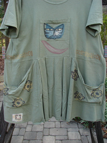 1995 PMU Blumenbeet Dress Kitty Kitty Marsh Size 1 features a cat face design, wider neckline, front and rear painted pockets, vertical pleats, and a swingy lower hem, showcasing vintage Blue Fish creativity.