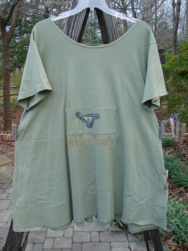 1995 PMU Blumenbeet Dress Kitty Kitty Marsh Size 1 on a clothesline, showcasing its wider neckline, front floppy pockets, vertical pleats, and detailed painted pockets.