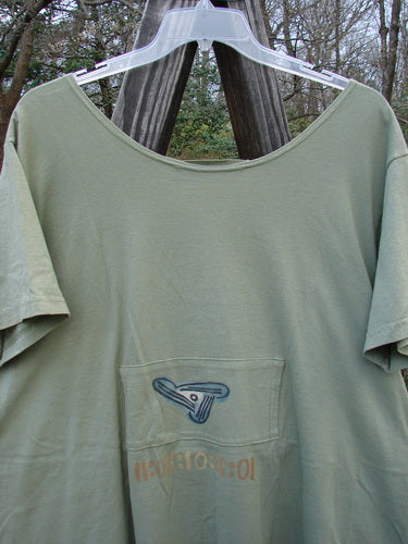 1995 PMU Blumenbeet Dress Kitty Kitty Marsh Size 1 on a hanger, featuring front and rear painted pockets, vertical center pleats, and a wide neckline.