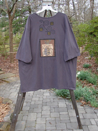 Barclay PMU Patched Big Square Over Top Home Beetle Currant Size 3 displayed on a rack, featuring a hand-drawn beetle design and patchwork detailing.