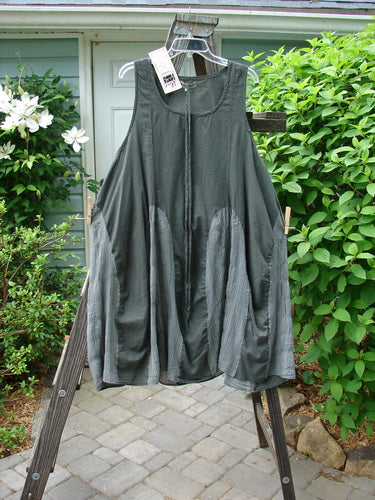 Barclay NWT Batiste Carousel Shift Jumper Unpainted Stripe Slate Size 2 displayed on a wooden rack, showcasing its sweeping A-line hem and side cord drawstrings.