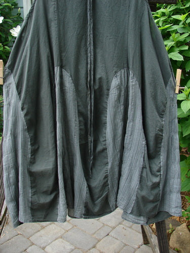 Barclay NWT Batiste Carousel Shift Jumper Unpainted Stripe Slate Size 2 hanging on a clothesline, showcasing its oval-shaped neckline, vertical stripes, and flowing A-line hem.