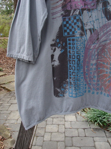 Barclay Long Sleeved Dip Side A Lined Tunic Daisy Logo Grey Storm Size 1 hanging on a clothesline, showing its rounded neckline, three-quarter sleeves, and longer shape.