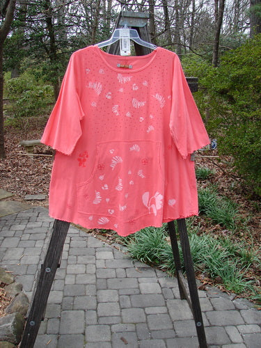 Barclay NWT Three Quarter Sleeved Cafe Pocket Top Fern Fall Geranium Size 1 displayed on a swing, showcasing its A-lined tunic shape, feminine neckline, rounded hemline, and double side-entry kangaroo pocket.