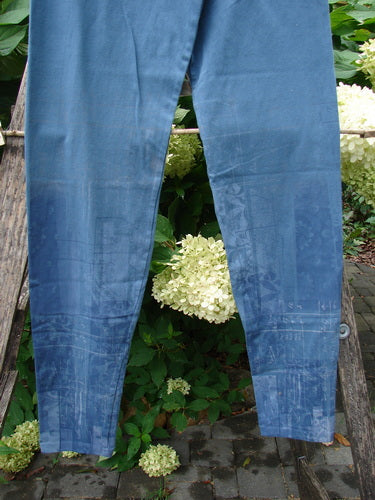 Barclay NWT Cotton Lycra Legging Light Scribe Echo Blue Size 1, slim-leg trousers, draped over a wooden ladder with lush green foliage and white hydrangeas in the background, showcasing elegant, tapering lowers.