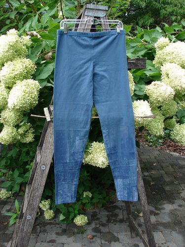 Barclay NWT Cotton Lycra Legging Light Scribe Echo Blue Size 1, shown on a hanger against lush greenery, features ankle-length design, slimming fit, and a soft, mid-weight fabric with a slightly mottled lower leg.