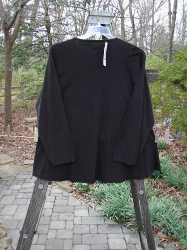 Barclay NWT Long Sleeved Cafe Tee in Black Cherry displayed on a hanger, featuring a rounded neckline, long cozy sleeves, and a swinging A-line shape with sweet curled edgings.