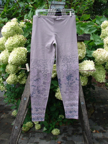Barclay NWT Cotton Lycra Basic Legging Tiny Botanicals Sea Fog Size 1 hangs on a trellis, showcasing its patterned design and full elastic waistband. Perfect for expressing individuality, available at Bluefishfinder.com.