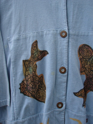 1993 Modernismo Cardigan Koi Periwinkle OSFA with fish designs, old-time buttons, curved kangaroo pockets, and a banded hemline. Features shoulder pleats and a drawcord back for a tailored fit.