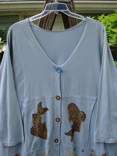 1993 Modernismo Cardigan Koi Periwinkle OSFA features a blue shirt with fish designs, old-time buttons, curved kangaroo tunnels, and a signature patch, in perfect vintage condition.
