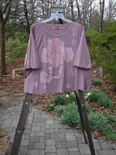 Barclay Three Quarter Sleeved Crop A Lined Tee Quad Blossom Red Stone Size 1 displayed on a swing, showcasing its A-line shape, rounded neckline, and detailed quad blossom design.