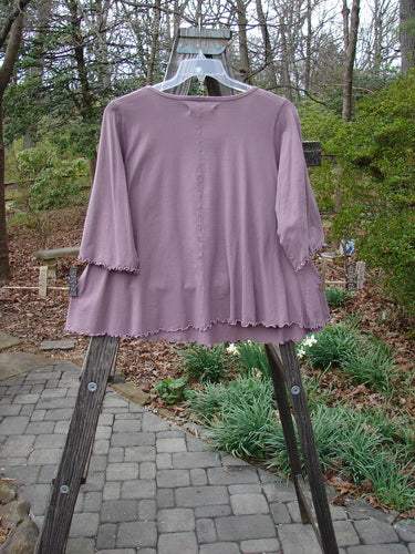 Barclay Three Quarter Sleeved Crop A Lined Tee Quad Blossom Red Stone Size 1 on a wooden stand, showcasing its graduating A-line shape, rounded neckline, and sweet curly edgings.