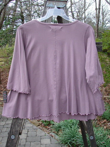 Barclay Three Quarter Sleeved Crop A Lined Tee Quad Blossom Red Stone Size 1 displayed on an outdoor hanger, showcasing its A-line shape, rounded neckline, and curly edgings.