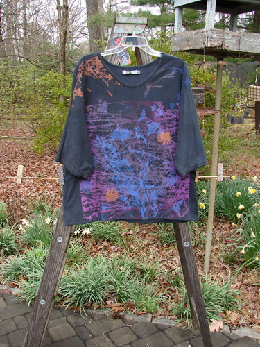 Barclay NWT Three Quarter Sleeved Euro Slim Golden Leaf Mottled Night Dye OSFA displayed on a wooden stand, showcasing its organic cotton fabric, oval neckline, straight shape, and dolman sleeves.