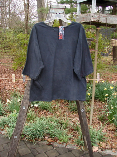 Barclay NWT Three Quarter Sleeved Euro Slim Golden Leaf Mottled Night Dye OSFA displayed on a wooden rack, showcasing its straight shape, rounded neckline, and dolman sleeves.