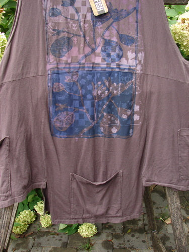 Barclay NWT Flower Pot Top Botanicals Brown Sparrow OSFA displayed on a bench, featuring a loose fit, long sleeves, and floral checkerboard print; showcases unique pockets and ribbed neckline.