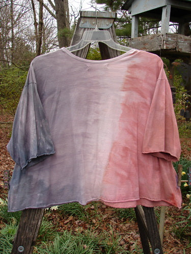 Barclay Three Quarter Sleeved Crop A Lined Tee on a wooden swinger, showcasing its flowy wind theme, rounded neckline, and curly edgings, in perfect condition, size 2.