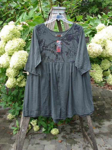 Barclay NWT Textured Terrarium Dress Contour Floral Ironworks Size 1, featuring a tunic style with 3/4 sleeves, empire waist, and floral print, displayed on a hanger against hydrangea backdrop.