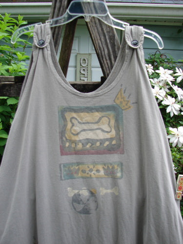 The 1995 Long Games Smock Jack Russell Pumice OSFA features a sweeping A-line shape, dual jet black buttons, detailed Jack Russell and beach ball paint, and deeper arm openings, reflecting Blue Fish's vintage creativity.