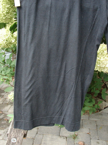 Barclay Basic Pocket Flare Pant Unpainted True Black Size 2 hangs outdoors, showcasing the hem and fabric texture amid lush greenery, embodying Bluefishfinder.com's vintage, expressive style.