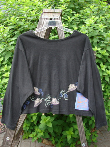 1997 NWT Long Sleeved Crop Tee Top Hat Ebony Size 2, featuring a wide, slightly A-lined shape, drop shoulders, and a top hat-themed design with a blue fish patch on a black background.