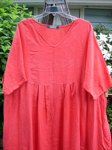 Barclay Linen Pleated Pocket Swing Dress in Geranium, features wide pleats and a curved empire waist. Includes inseam pockets and a drawcord rear, highlighting BlueFishFinder's vintage aesthetic. Size 2, 44-inch length.