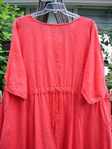 Barclay Linen Pleated Pocket Swing Dress in geranium, size 2, featuring wide pleats, a curved empire waist, low inseam pockets, and generous short sleeves, showcasing BlueFishFinder's vintage style.