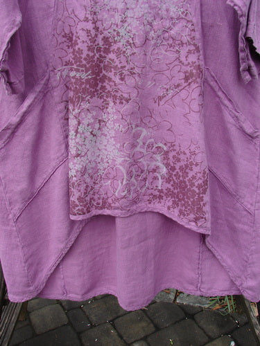 Barclay NWT Linen Poset Tunic Dress Clover Field Orchid Size 0, featuring a floral design, oval neckline, flowy figure-eight shape, three-quarter sleeves, and two front pockets.