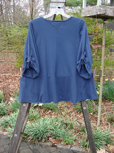 Barclay Draw Sleeve Cafe Tunic Moon Gull Denim Size 1 displayed on a wooden stand, showcasing its rounded neckline, A-line shape, wide sleeves, and sweet rolled edgings.