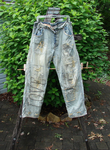 Magnolia Pearl NWT Guadalupe Love Ranchero Miner Jean in Washed Indigo features distressed edges, rear embroidery, and continuous patching, embodying creative individuality. This design includes adjustable rear buckle, button fly, and generous leg width.