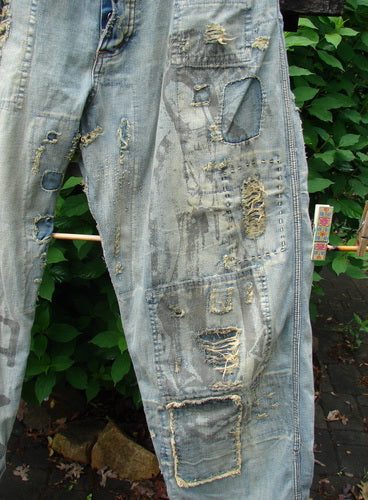 Magnolia Pearl NWT Guadalupe Love Ranchero Miner Jean in Washed Indigo, featuring adjustable rear buckle tab, full button fly, rear embroidery, distressed edges, continuous patching, and generous leg width.