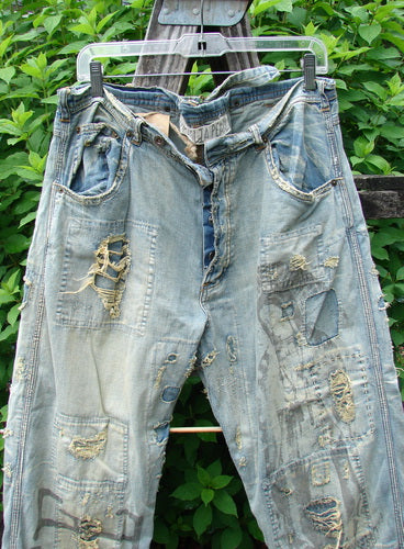 Magnolia Pearl NWT Guadalupe Love Ranchero Miner Jean in Washed Indigo features a full button fly, distressed edges, adjustable rear buckle, rear embroidery, and continuous patching, exemplifying Bluefishfinder.com's vintage-inspired, creative fashion ethos.