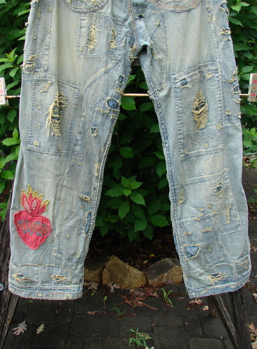 Magnolia Pearl NWT Guadalupe Love Ranchero Miner Jean in Washed Indigo OSFA features adjustable rear buckle, full button fly, rear embroidery, distressed edges, continuous patching, dual rear pockets, and generous leg width.