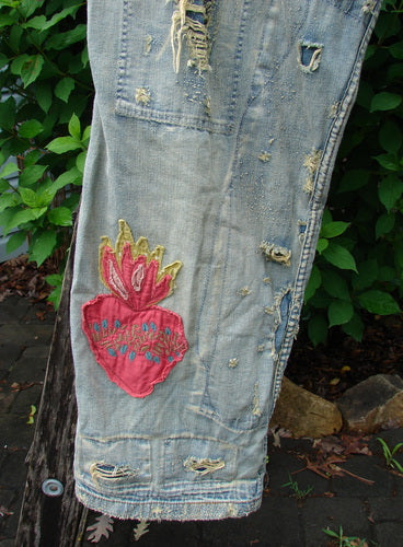 Magnolia Pearl NWT Guadalupe Love Ranchero Miner Jean in Washed Indigo features a full button fly, rear embroidery, distressed edges, dual rear pockets, and adjustable rear buckle tab, embodying vintage-inspired craftsmanship.