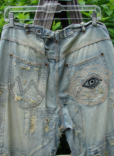 Magnolia Pearl NWT Guadalupe Love Ranchero Miner Jean in Washed Indigo features distressed edges, rear embroidery, hand mending, and continuous patching, embodying BlueFishFinder's vintage, expressive style.