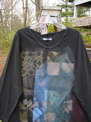 Barclay NWT Long Sleeve Studio Tee in Metallic Mosaic Black, features an oval neckline and slight A-line shape, displayed in perfect condition, highlighting the intricate blue and yellow design on the front.