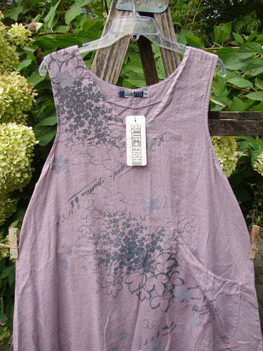 Barclay NWT Linen Explorer Jumper Tiny Botanical Sea Fog Size 0, featuring a sleeveless design with black floral print, scoop neckline, upper pocket, and adjustable drawcord back, hanging on a clear hanger outdoors.