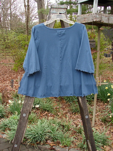 Barclay Three Quarter Sleeved Crop A Lined Tee Play Dress Up Navy Size 0 featuring a unique graduated A-line shape, rounded neckline, and curly edgings, showcased on a clothes rack.