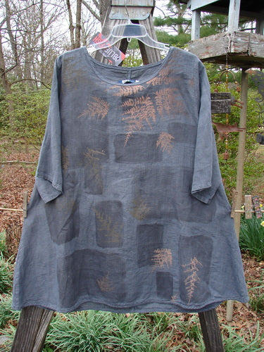 Barclay NWT Linen Lucida Top Fern Fare Steel Blue Diatom Size 0, featuring brown leaf designs, a rounded neckline, flowy A-line shape, and almost three-quarter sleeves, displayed on a hanger.