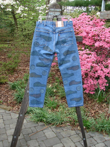 1995 Levi Strauss & Co Denim Blue Jean Travel Dark Stone Wash Size 1 with travel-themed pattern, front rounded and rear exterior pockets, orange Levis tag, and blue fish patch.