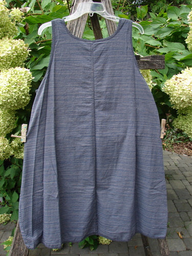 Barclay NWT Light Weight Chambray Shift in Stripe Denim Dark Size 0 displayed on a clear hanger, showcasing a sleeveless design with an A-line shape, rounded neckline, and subtly striped fabric.